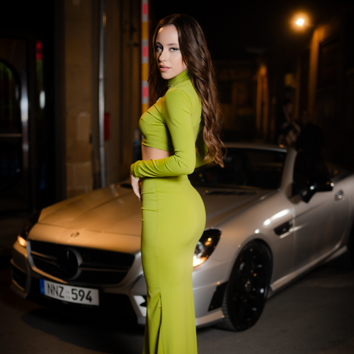 woman in vibrant green two-piece outfit