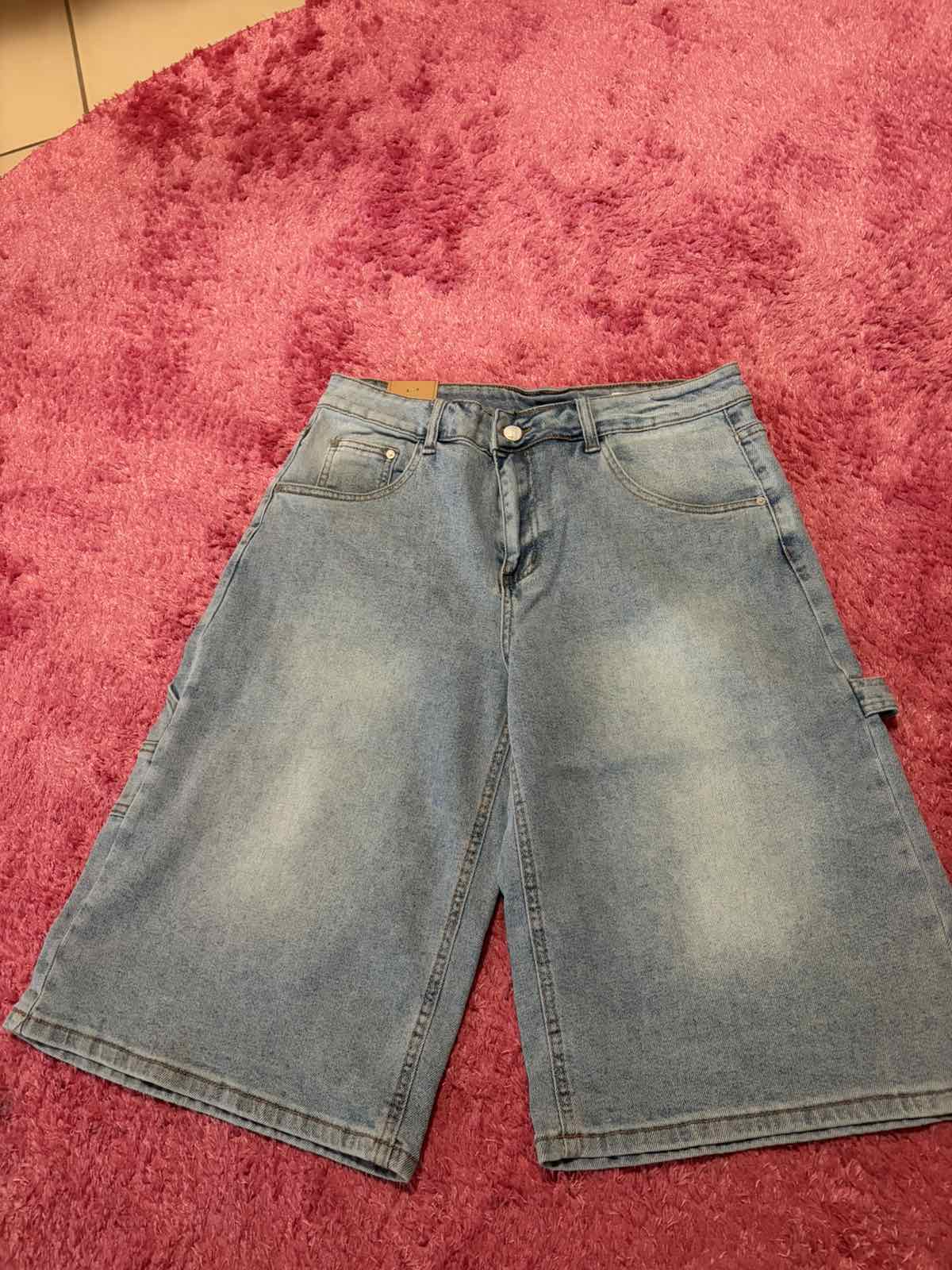 Front view of light-wash utility denim Bermuda shorts